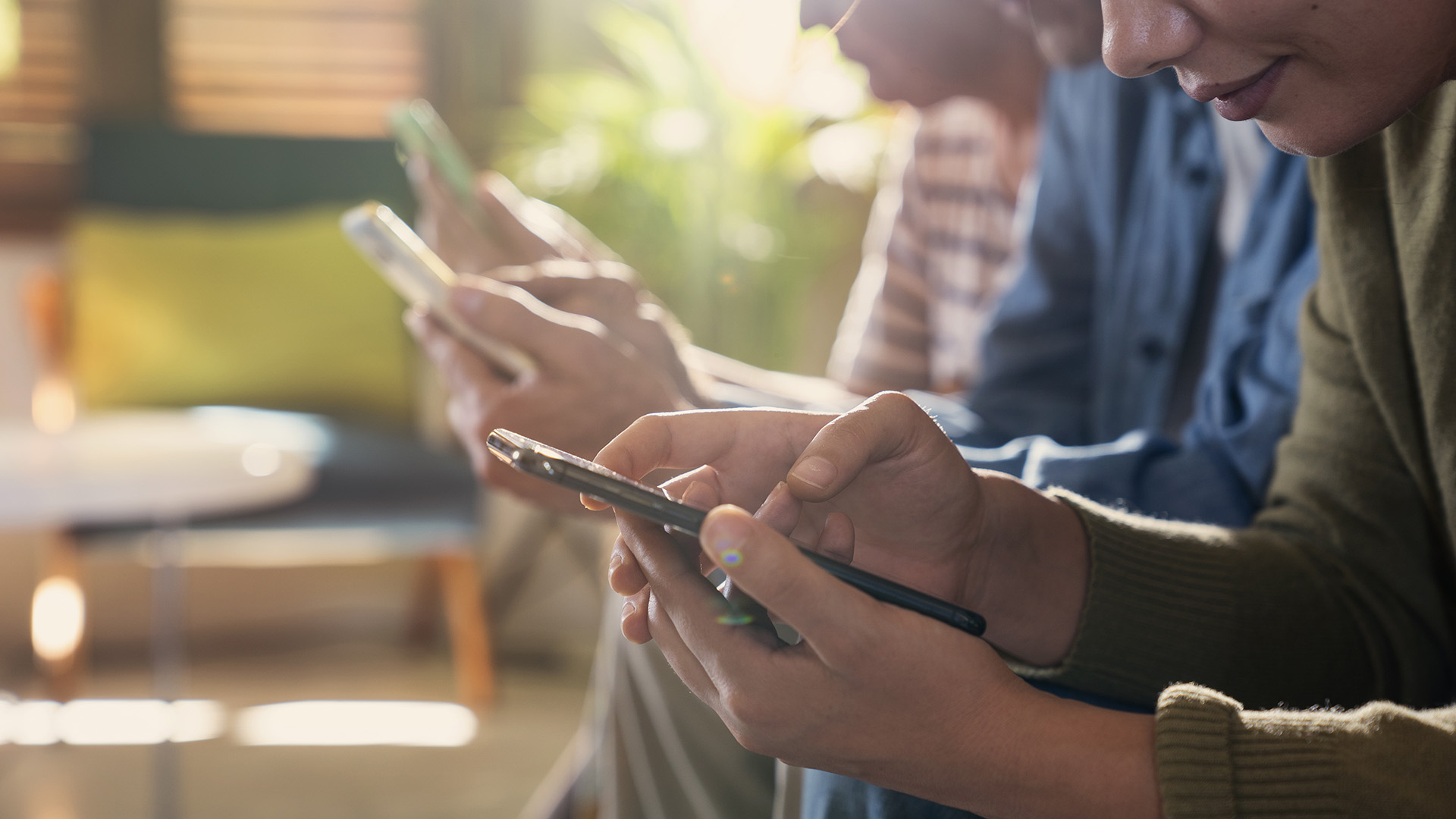 Group of people looking at their smartphones.